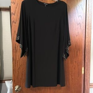 Classy black dress with sequin trim flowing sleeves. Excellent condition.